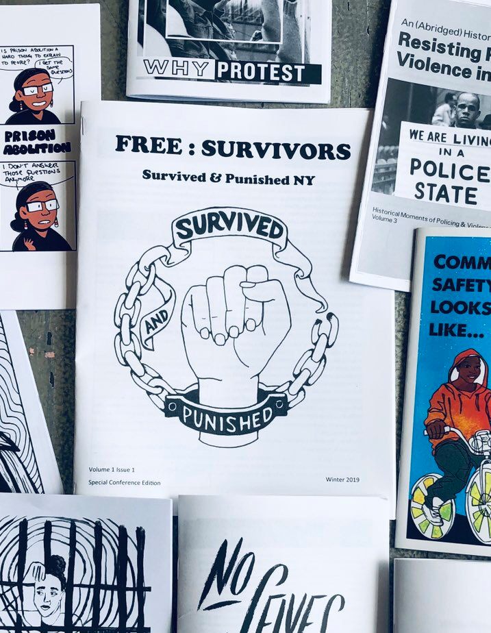 A picture of the first issue of Survived and Punished NY magazine surrounded by other publications posted to a cork board.